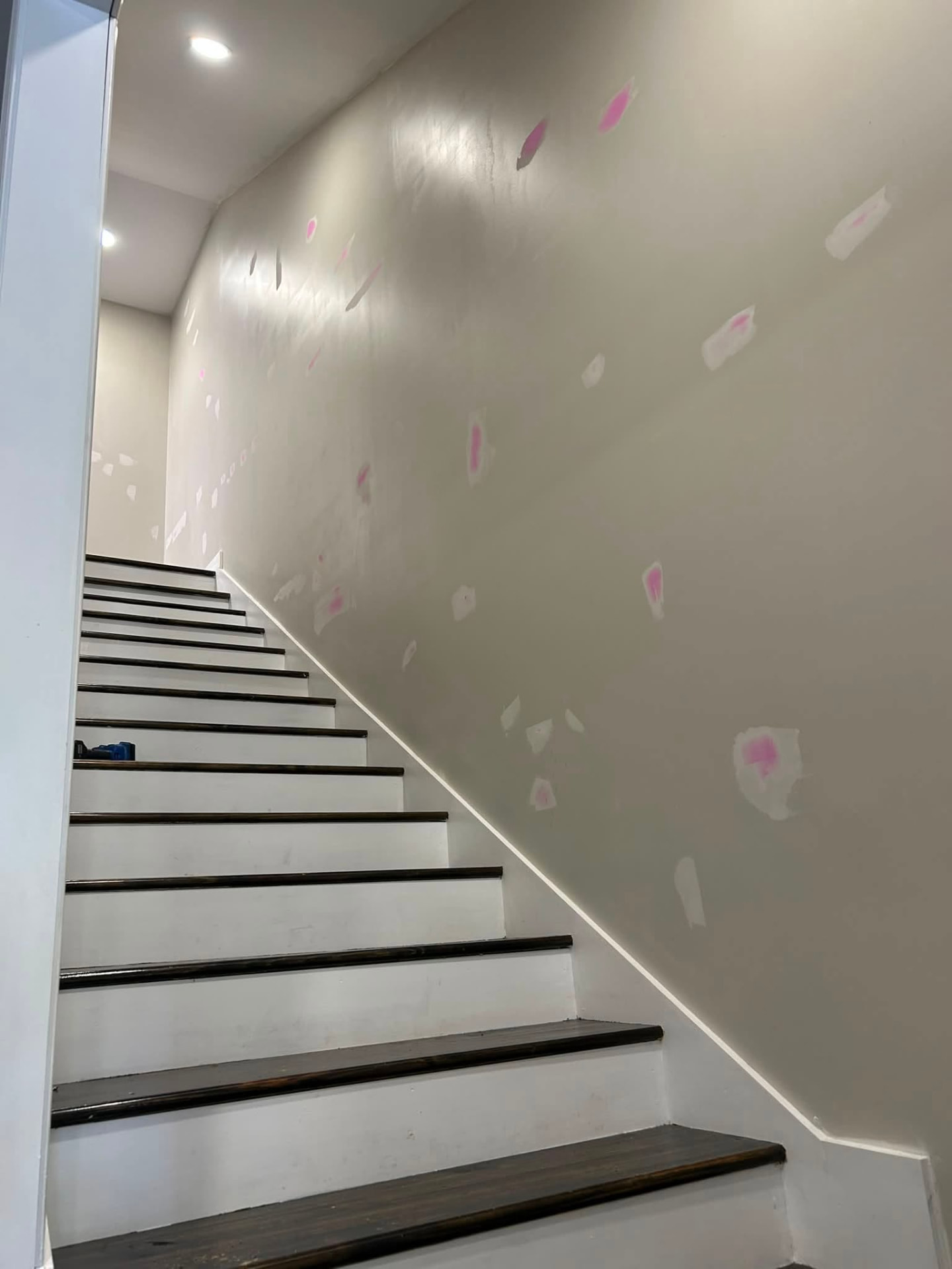 Stairwell wall patched and primed before painting